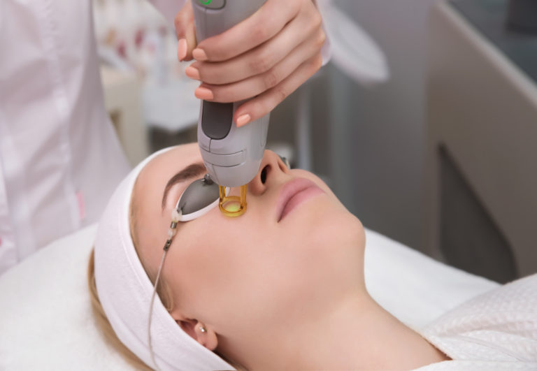 A Woman getting Laser Treatment on face | Halina Spa in Round Rock & Austin, TX